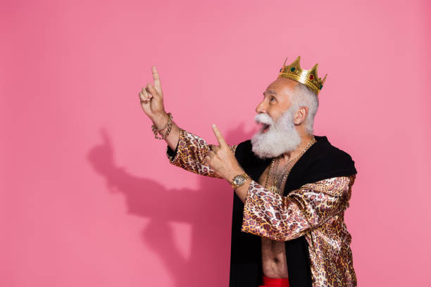 istock Portrait of excited aristocrat man leopard coat crown indicate fingers up empty space isolated on pink color background 2193689714