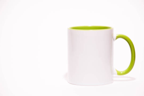 Cup on a white background. Green mug. Green cup or mug isolated on white. Coffee cup. Empty green tea cup. White and green ceramic cup