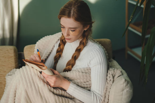 istock Enjoying a Cozy and Creative Writing Session on a Relaxing Winter Afternoon at Home 2193693325