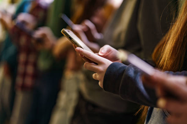 Close-up of mobile phones in children's hands stock photo