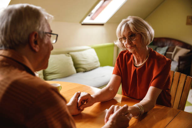 istock Romantic senior couple holding hands while enjoying morning coffee 2193693625
