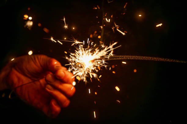 istock Hand holding burning sparkler, Christmas. 2193694928