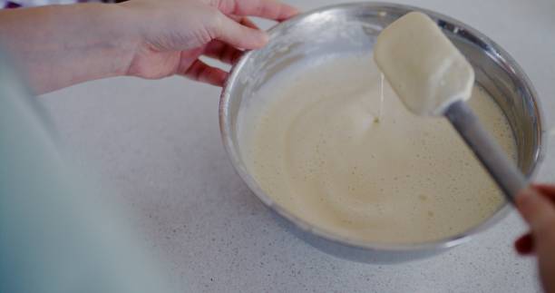 istock Woman Checking Pancake Batter Density with Plastic Dough Spatula 2193695307