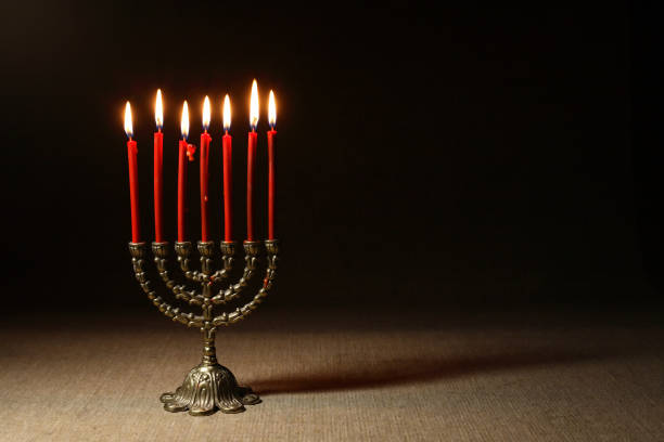 Traditional jewish menorah with lighting candles on nice dark background