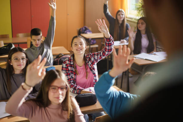 istock Children raising hands to answer the teacher's question 2193698062