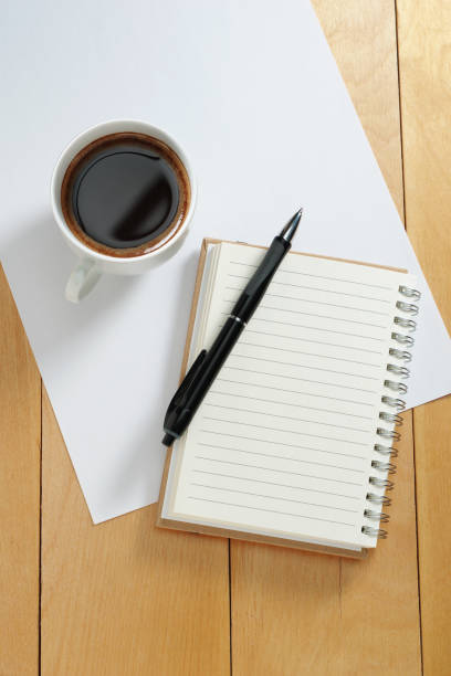 istock Notebook with pen and cup of coffee 2193698466