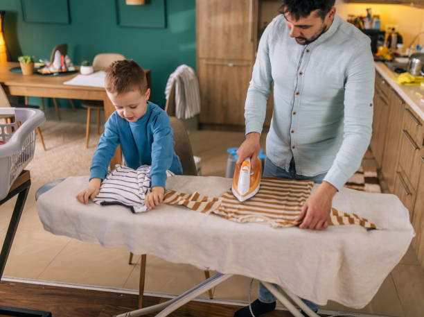 istock young dad ironing children's clothes 2193699937