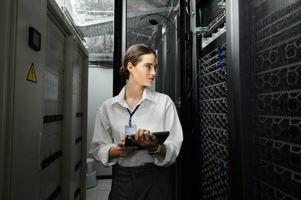 istock Young woman managing cloud systems in a modern server room with advanced hardware 2193700727