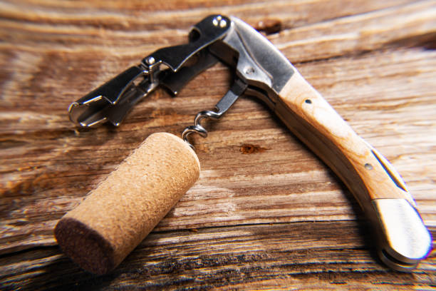 istock corkscrew and cork close-up on a textured wooden background. macro. Selective focus. 2193701301