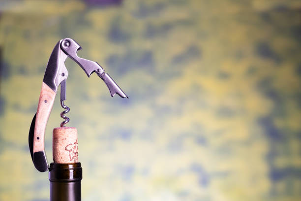 istock sommelier or waiter knife pulls out a cork from the bottle of wine. Blurred background space for text. 2193701875