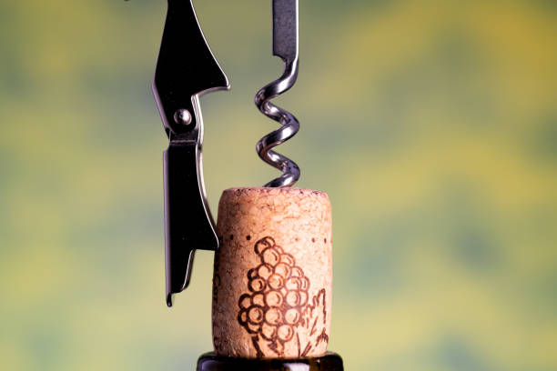 istock sommelier knife pulls out a cork from the bottle of wine. Macro. Blurred background. space for text. 2193701882