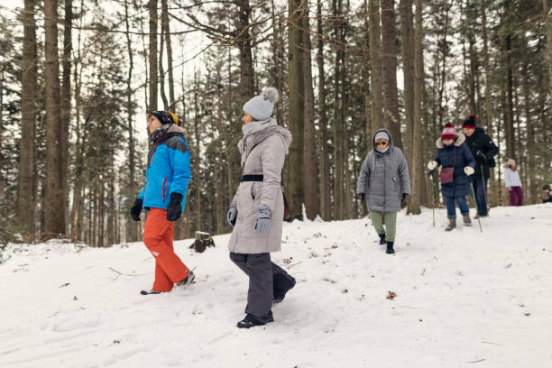 istock Multi-generation family walking and chatting in winter forest 2193703428