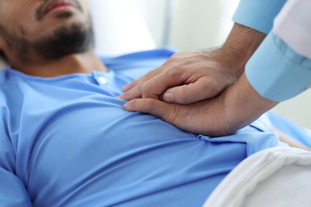 istock Doctor examining patient lying in hospital bed. 2193704938