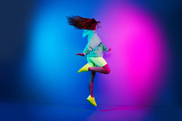 istock Full length photo of shiny attractive lady dressed green sweatshirt jumping high empty space isolated blue light color background 2193706607