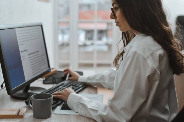 istock Beautiful Teacher Checking Her CV For Grammatical Mistakes Before Applying For New Job 2193706809
