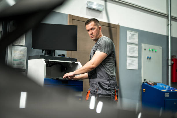 istock Mechanic using a computer in a auto repair shop 2193708897