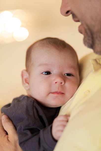 istock Cute baby in hands of crop anonymous father 2193711241