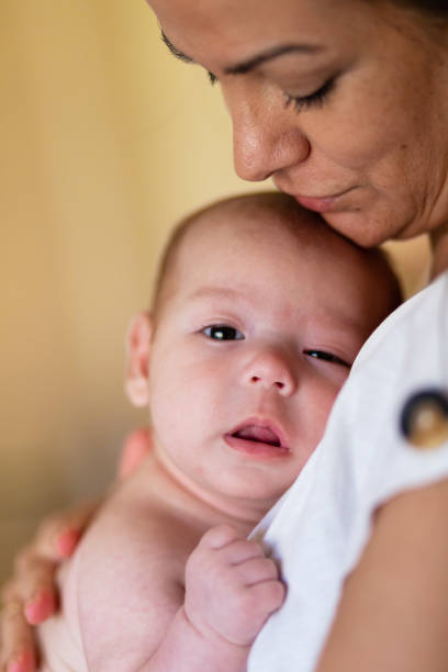 istock Loving mother hugging newborn at home 2193711421