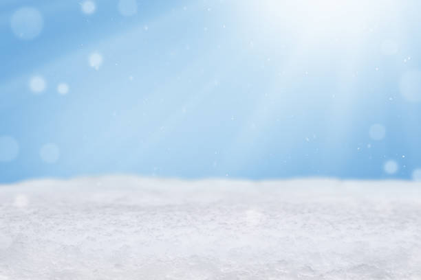 Christmas background with snowdrift, falling snow and sun rays with copy space. Empty winter background. Banner, website header, poster with cope space.