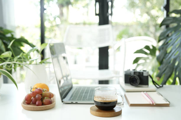 istock laptop and coffee cup with notebook and plants pot and orange on white table work from home 2193712058
