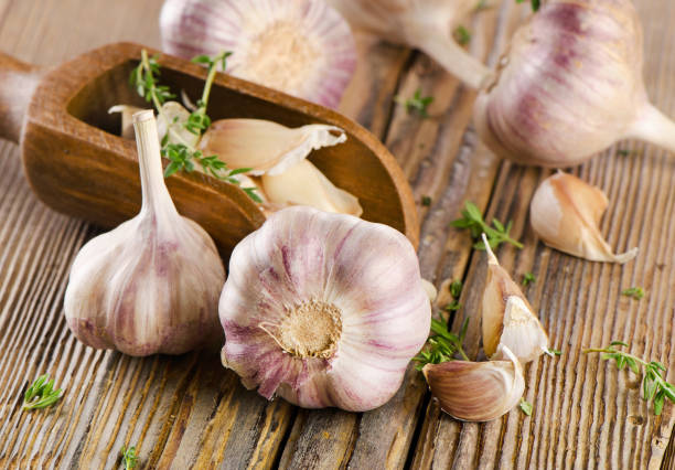 istock garlic  on  a wooden board 2193712287