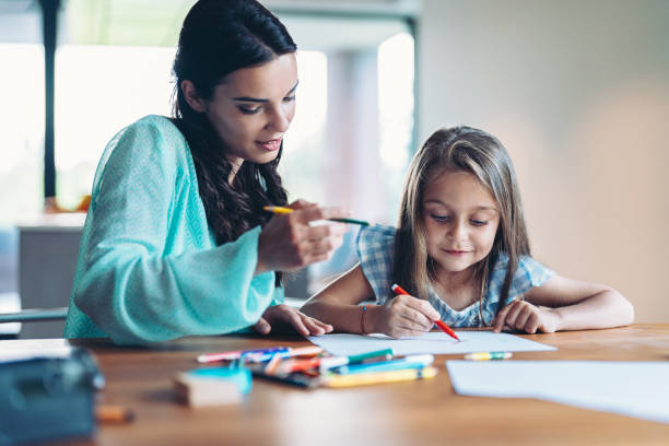 istock Mother and little daughter drawing together 2193712297