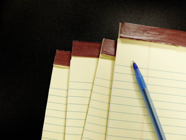 istock Legal Pad Notebooks on Desk with Pen 2193714017