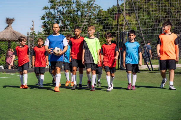 istock Kids Practicing Together Under a Coach's Guidance on a Soccer Field 2193714453