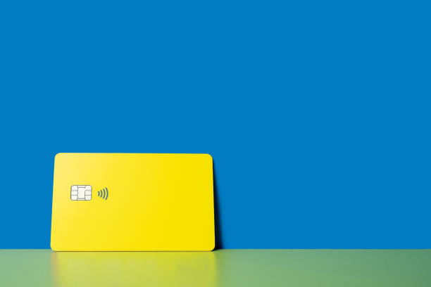istock yellow credit card on an blue background 2193714479