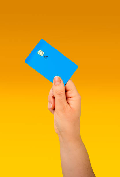 istock woman holding a blue credit card 2193714490