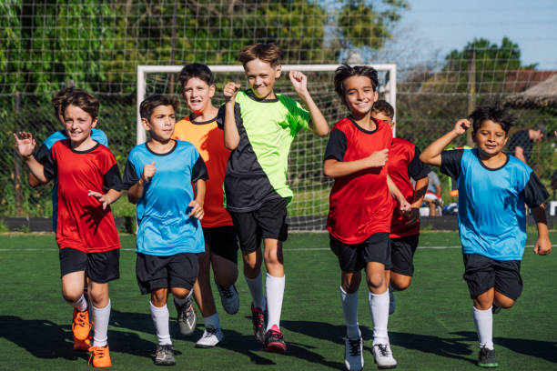 istock Group of Kids Playing Soccer on the Field During Team Practice 2193714596