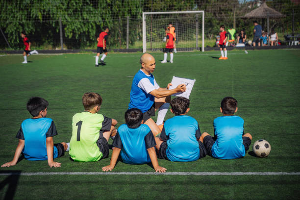 istock Coach Explaining Soccer Strategy to Youth Players on a Training Field 2193714616