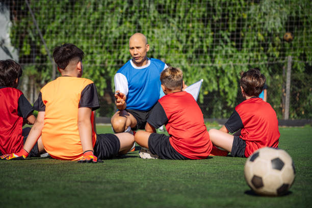 istock Coach Providing Guidance to Young Soccer Team Before Practice 2193715353