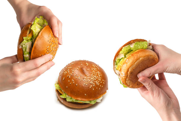 istock Hamburger in woman hands isolated on a white background. 2193715553