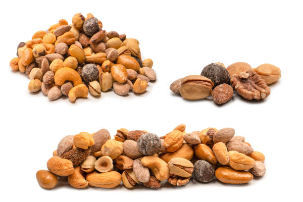 Mix of tasty salty nuts.  A group of almonds, pistachios, walnuts, macadamia, cashews.