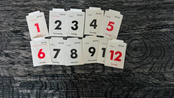 Calendar sheets of the beginning year on a black table