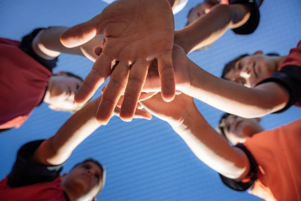 istock Youth Soccer Team Huddling Hands Together in Unity 2193716083