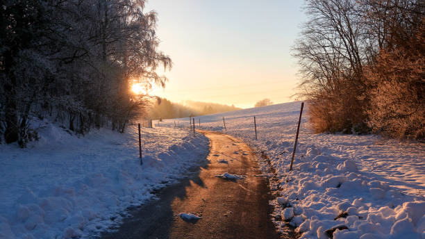 Winter landscape, open rural road in the sun