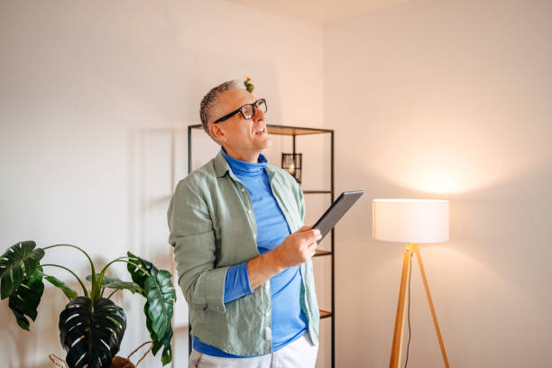 istock Middle age man spending time home alone in living room and enjoying it 2193720507