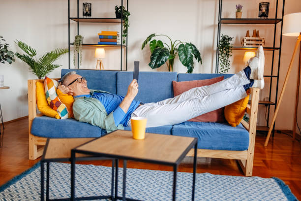 istock Middle age man spending time home alone in living room and enjoying coffee 2193720558