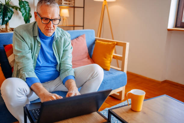 istock Middle age man spending time home alone in living room and enjoying coffee 2193720726