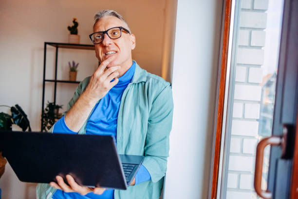 istock Middle age man spending time home alone in living room and enjoying it 2193720759