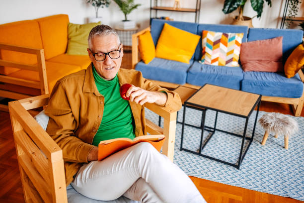 istock Middle age man spending time home alone in living room and enjoying it 2193720898