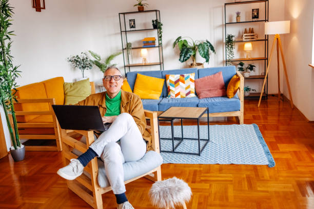 istock Middle age man spending time home alone in living room and enjoying it 2193721046