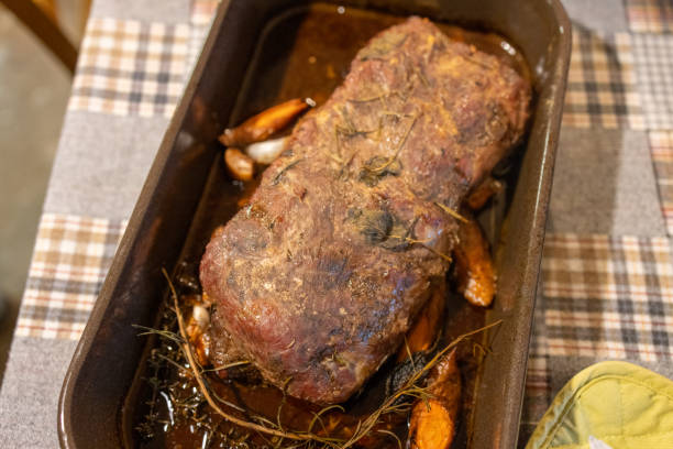 istock Rustic Oven-Roasted Meat with Herbs and Vegetables 2193723363