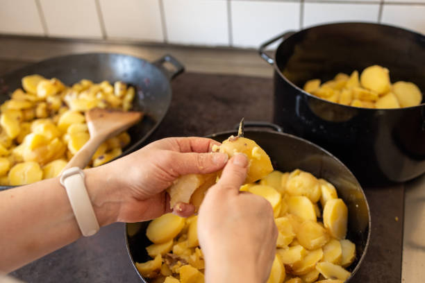 istock Hands Peeling Potatoes for a Hearty Homemade Meal 2193723794