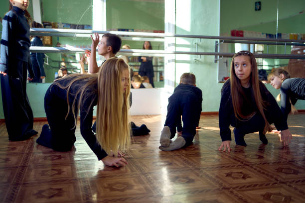 istock a group of pre-teens perform a teacher's task during an acting class, imitation of animals, quadrobing 2193724921