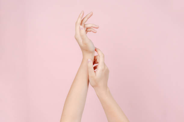 istock Manicured nails, beautiful woman hands forming an elegant shape on pink background 2193725391