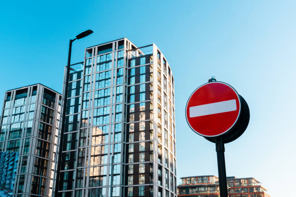 istock No entry sign stands before modern apartment buildings under blue sky 2193725614