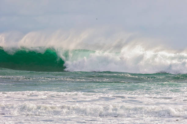 istock Big wave with splashes on the ocean coast 2193727096